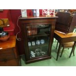 A late Victorian walnut bookcase, the single glazed door with working lock and key, the height