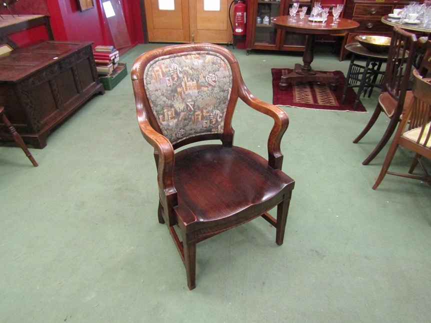 A circa 1900 oak scroll arm desk chair the dished seat over square tapering fore legs joined by