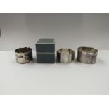 Two silver napkin rings and a boxed example marked Sterling
