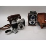 A Zeiss Ikon Contaflex camera with cased BWEI exposure meter and a lens hood. Also, a Halina twin