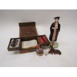 A Royal Doulton 'The Graduate' figure, Goebel figure 'Apple tree girl' pony and games box (4)