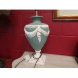 An urn shape table lamp base, green ground with white swags