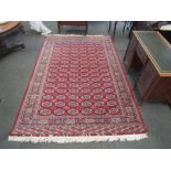 An Eastern red ground rug with geometric gulls and multiple borders, 300cm x 200cm, a/f