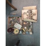 A box and tray of tools, door knockers, tape measures etc.