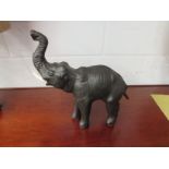 A vintage leather figure of an elephant, 33cm high