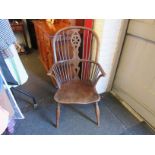 An elm wheel back Windsor chair on 'H' stretcher base