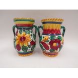 Two Majolica urn style vases with twin handles and floral design, marked Italy to bases, 15.5cm tall