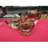 A Doulton harvest stoneware teapot together with two jugs, silver bands (3)