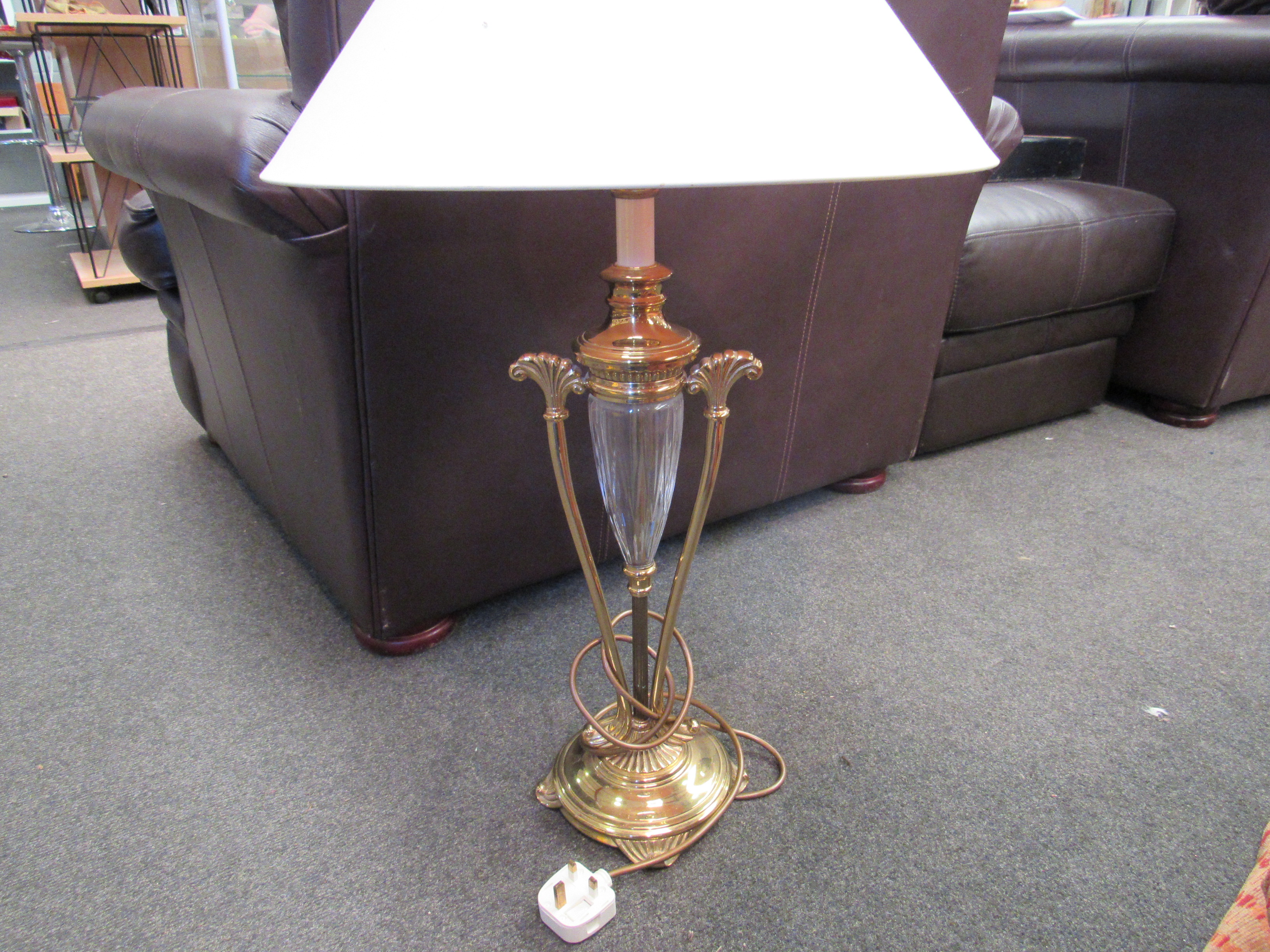 A modern brass effect and glass lamp with shade