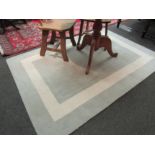 A modern Laura Ashley Home rug with square design to centre, 200cm x 140cm