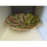 A Continental country pottery bowl, painted foliate detail in green, blue and brown. 31.5cm diameter