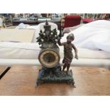 A late 19th century painted spelter timepiece with figure of girl standing beside the clock