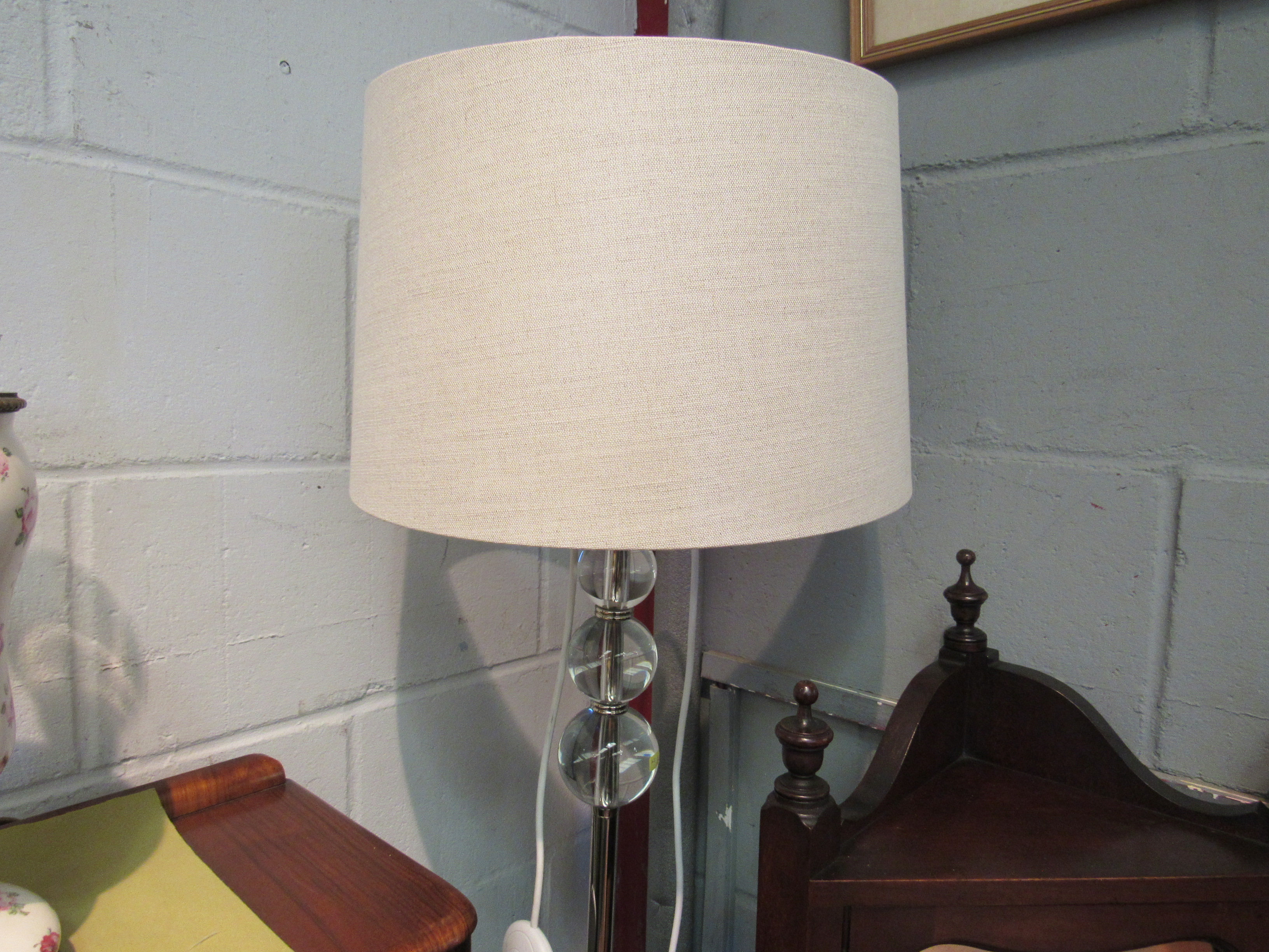 A modern standard lamp with clear ball detail