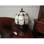 A Tiffany style bronzed table lamp with red and white leaded glass shade, 36cm tall