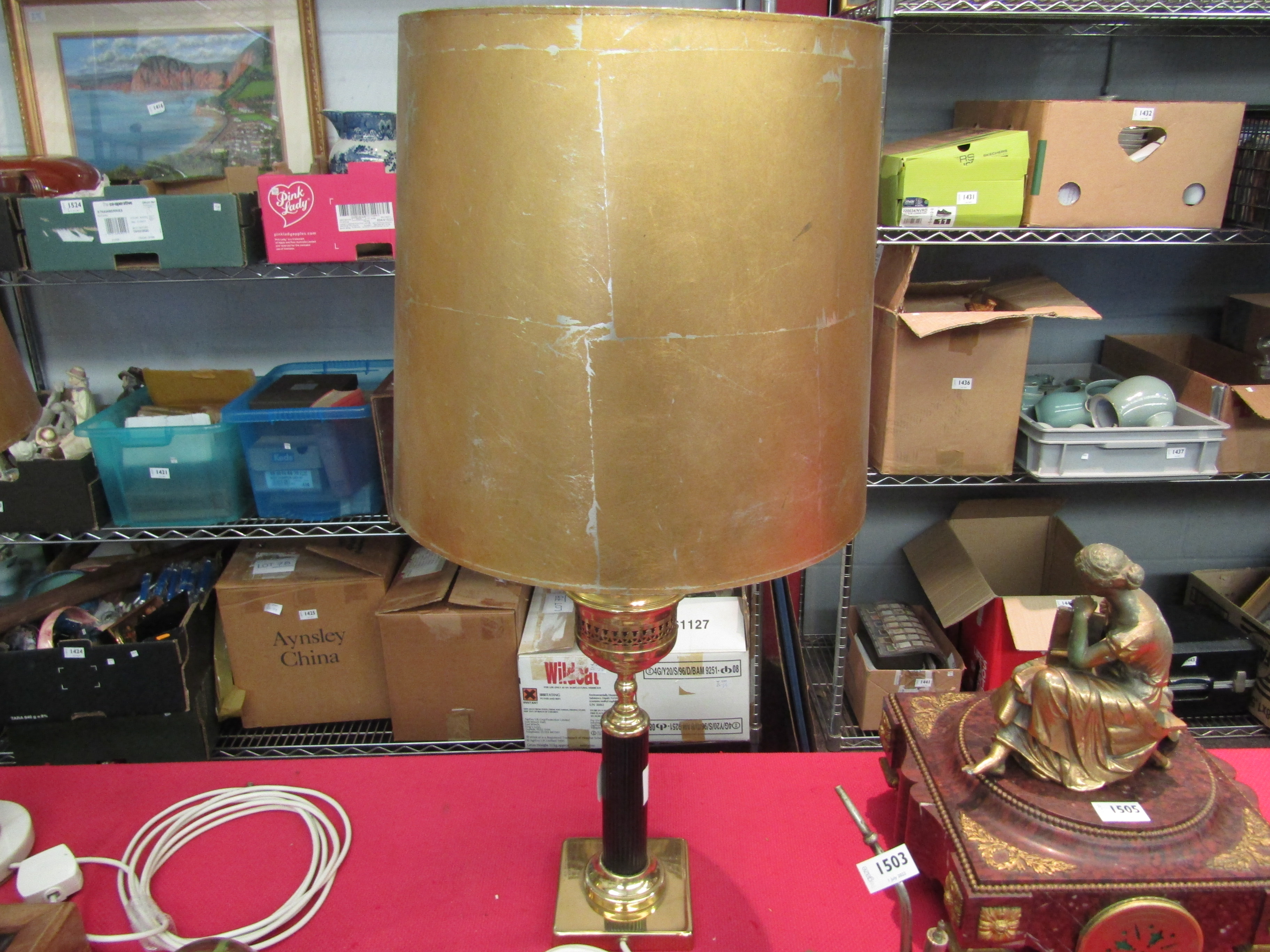 A column form brass table lamp base with distressed gilded shade