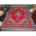 An Eastern wool red ground rug, 400cm x 295cm