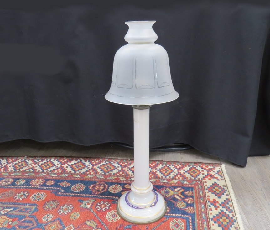 A 19th Century milk glass column candle lamp with gilt banding and blue snake coiled to base (