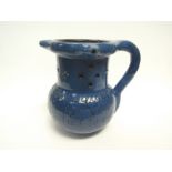A C.H. Brannam blue glazed pottery puzzle jug with foliate design and impressed mark to base, 14cm