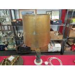 A marble and gilt table lamp base with distressed gilded shade