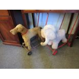 A vintage careworn Tri-ang push-along dog together with a push-along elephant