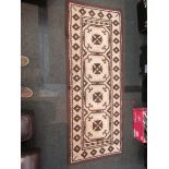 A small woollen rug with matching runner