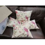 Four decorative cushions with bird and tree design