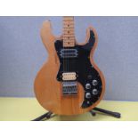 A Peavey T-60 electric guitar with natural body, black pickguard, replacement bridge pickups, serial