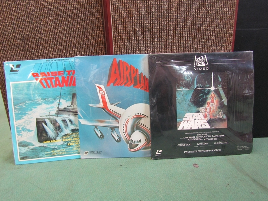 Three laserdisc videos to include 'Star Wars', 'Airplane' and 'Raise The Titanic'