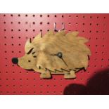 A Welsh (West Glamorgan Pineneedles crafts) wooden wall clock, in the form of a hedgehog
