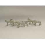 A set of seven miniature white ceramic horses