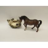 A Beswick horse and a Winstanley cat in a playful pose