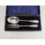 A cased silver fork and spoon with figural scenes