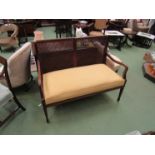 An Edwardian bergere mahogany two seater sofa on square tapering legs