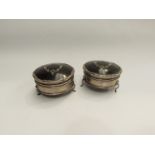 A pair of silver and tortoiseshell trinkets pots on feet, one a/f