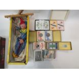 A tin containing boxes of vintage playing cards together with a boxed Pelham puppet, 'clown'