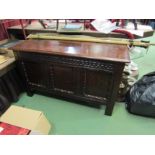 A 17th Century oak three panel coffer the hinged lid over a chip carved front on stile feet, 67cm