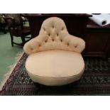 A late Victorian button back parlour chair on ebonised turned feet and ceramic castors