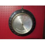 A Victorian ebonised frame Salom & Co., London/Edinburgh wall mounted circular barometer