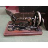 A Singer sewing machine in wooden case