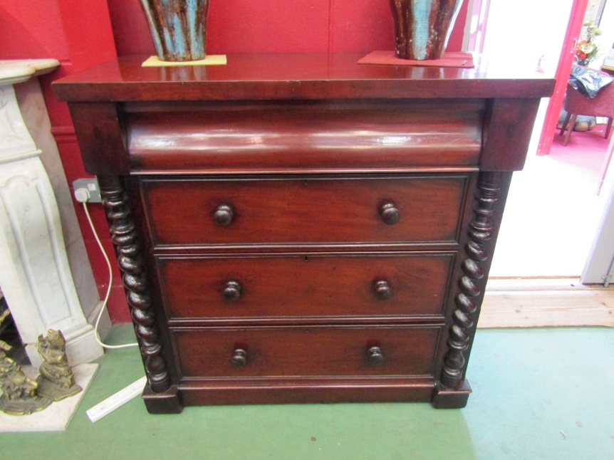 A mid-Victorian mahogany Scottish chest of four graduating long drawers flanked by turned spiral