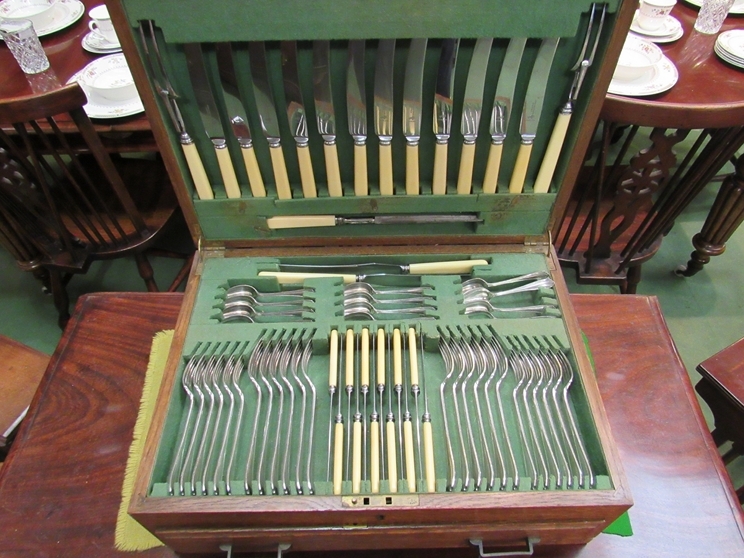 An Atkins brothers silver plated 12 place setting oak cased canteen of cutlery