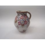 A Charlotte Rhead floral jug, 22cm tall