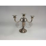 A silver three sconce candelabrum, scrolled detail, stepped base, stamped sterling to base