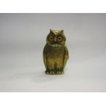 A Victorian brass owl vesta holder