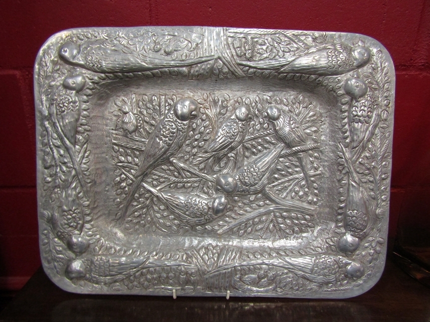 A heavily embossed rounded rectangular tray depicting parakeets, 49cm long