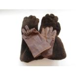 A pair vintage leather and fleece winter motorcycle gauntlets along with a pair of leather driving