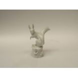 A Meissen squirrel figure, crossed sword marks to base, small chip to ear. 14.5cm high