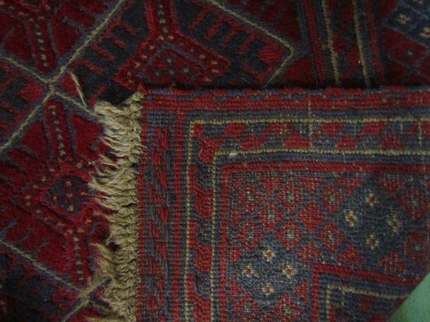A square rug with diamond geometric patterned centre on red ground with tasselled ends, 125 x 125cm - Image 2 of 2