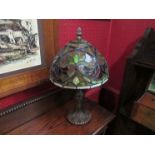 A Tiffany style lamp with leaded glass shade. 35cm tall (repair to base shade supports)