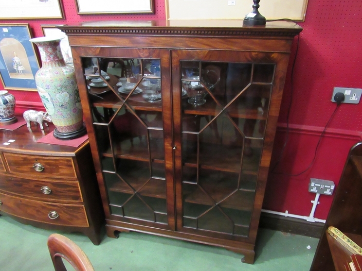 A George III flame mahogany astragal glazed two door bookcase the height adjustable shelves over